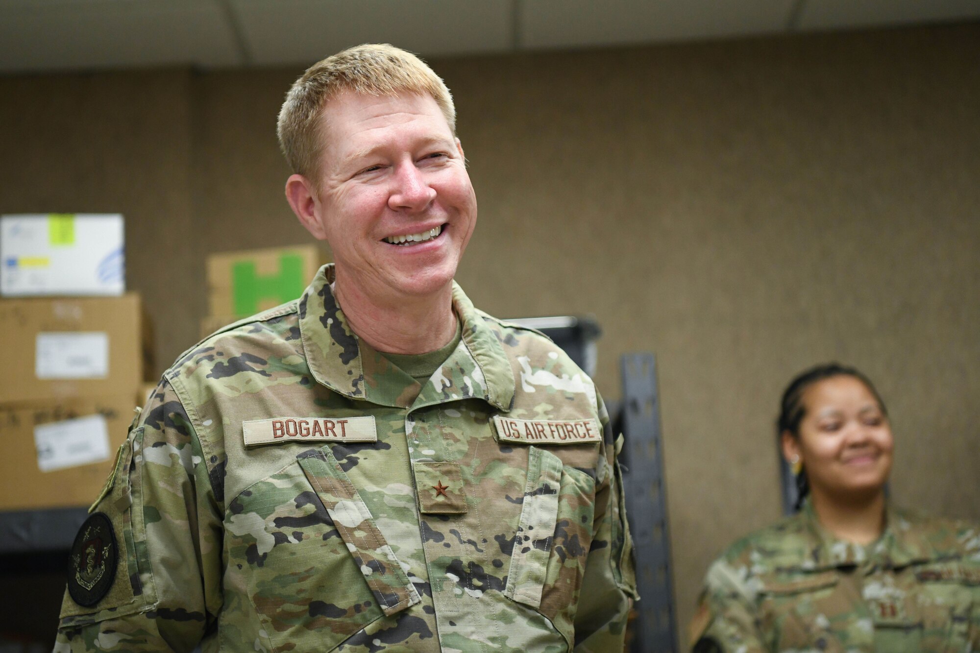 Man in military uniform smiles.