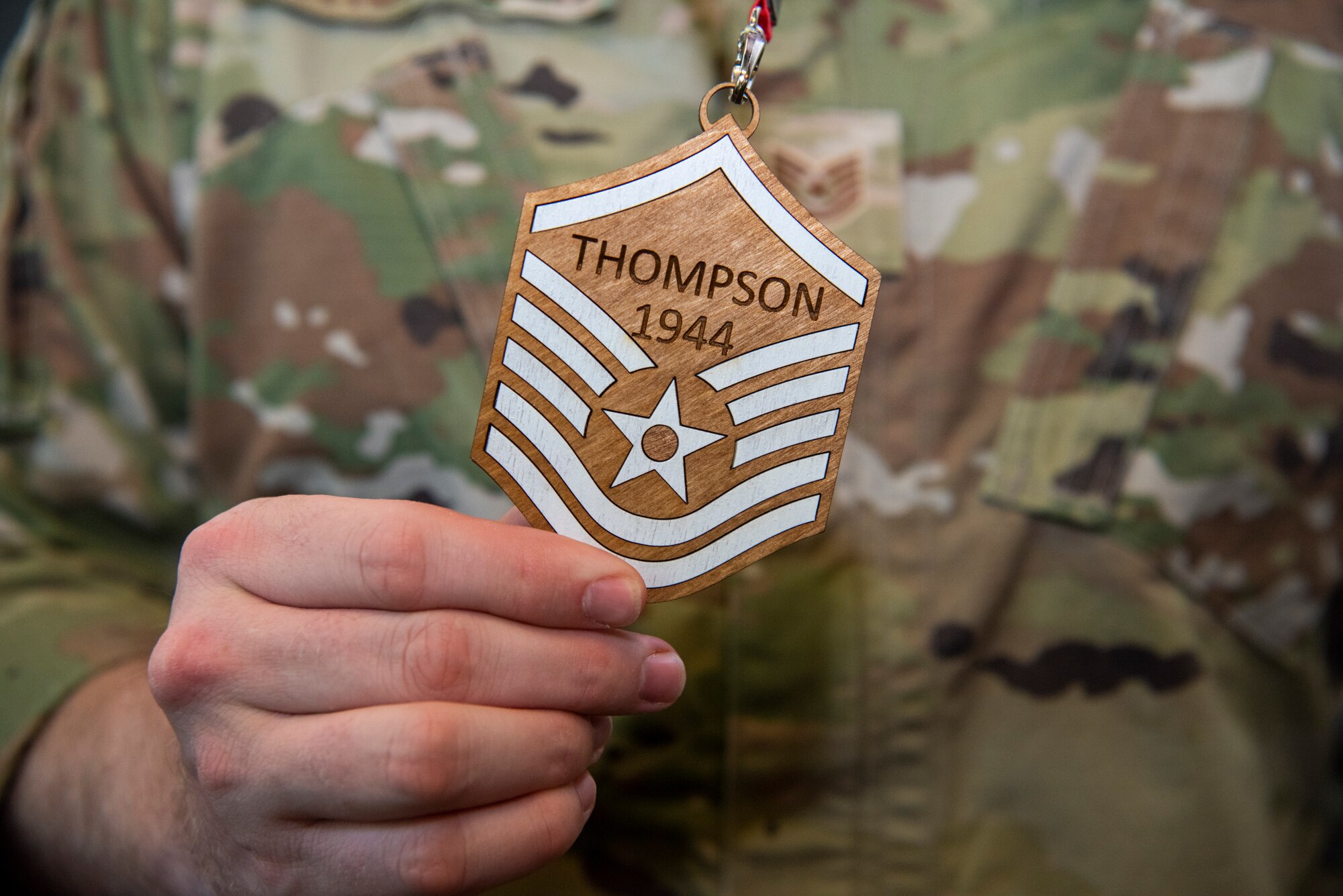 U.S. Air Force Tech. Sgt. Peter Thomspon, 86th Airlift Wing Public Affairs mission partner support non-commissioned officer in charge, holds a line-number plaque at the master sergeant promotion release party at Ramstein Air Base, Germany, June 2, 2023.