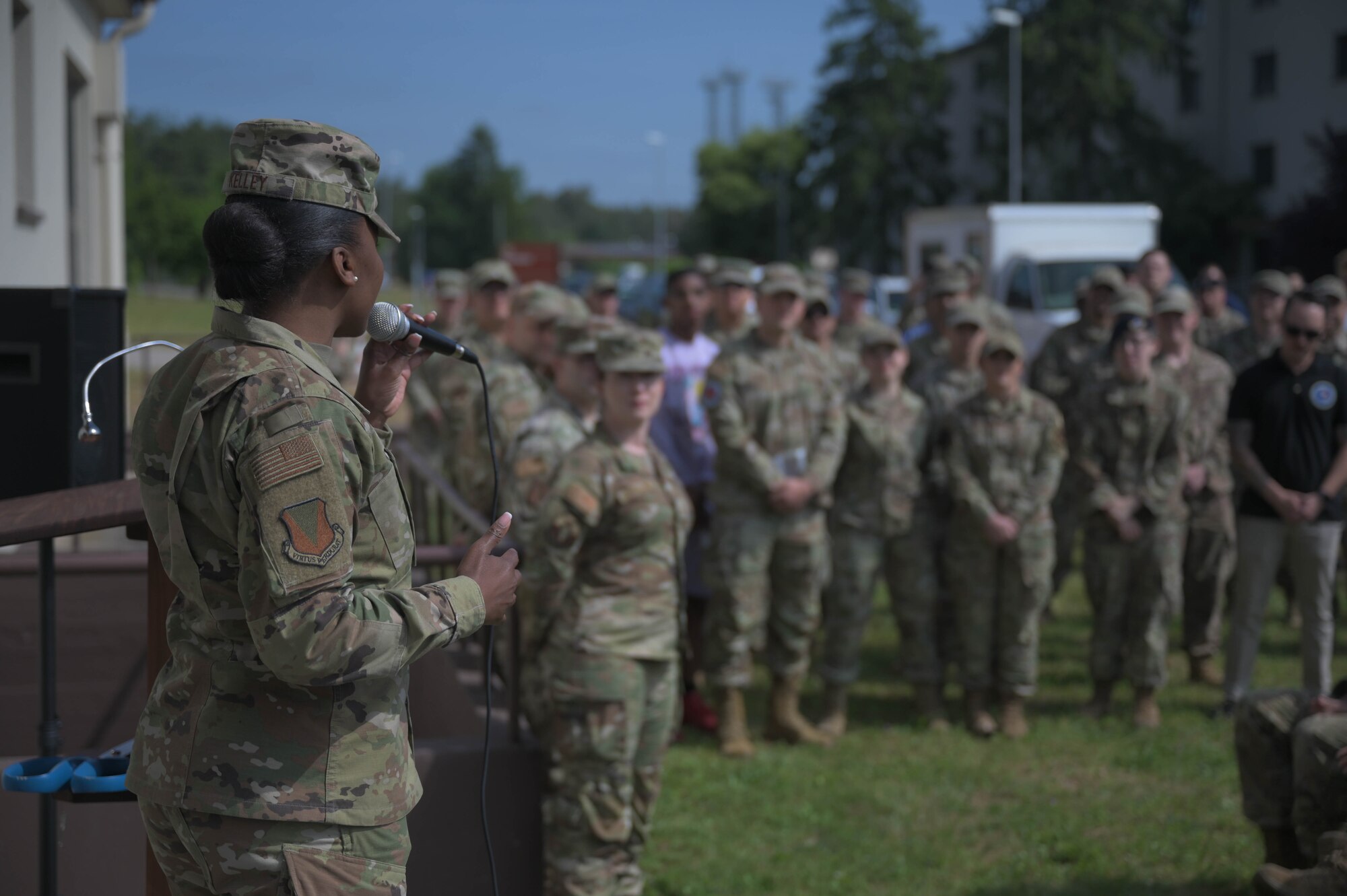 U.S. Air Force Chief Master Sgt. Charmaine Kelly, 86th Airlift Wing command chief, speaks to a crowd at Ramstein Air Base, Germany, June 2, 2023. The newly-opened Den features many facilities for Airmen to utilize, such as a game room, music room, and multiple rooms for relaxing. (U.S. Air Force photo by Senior Airman Johnny Foister)