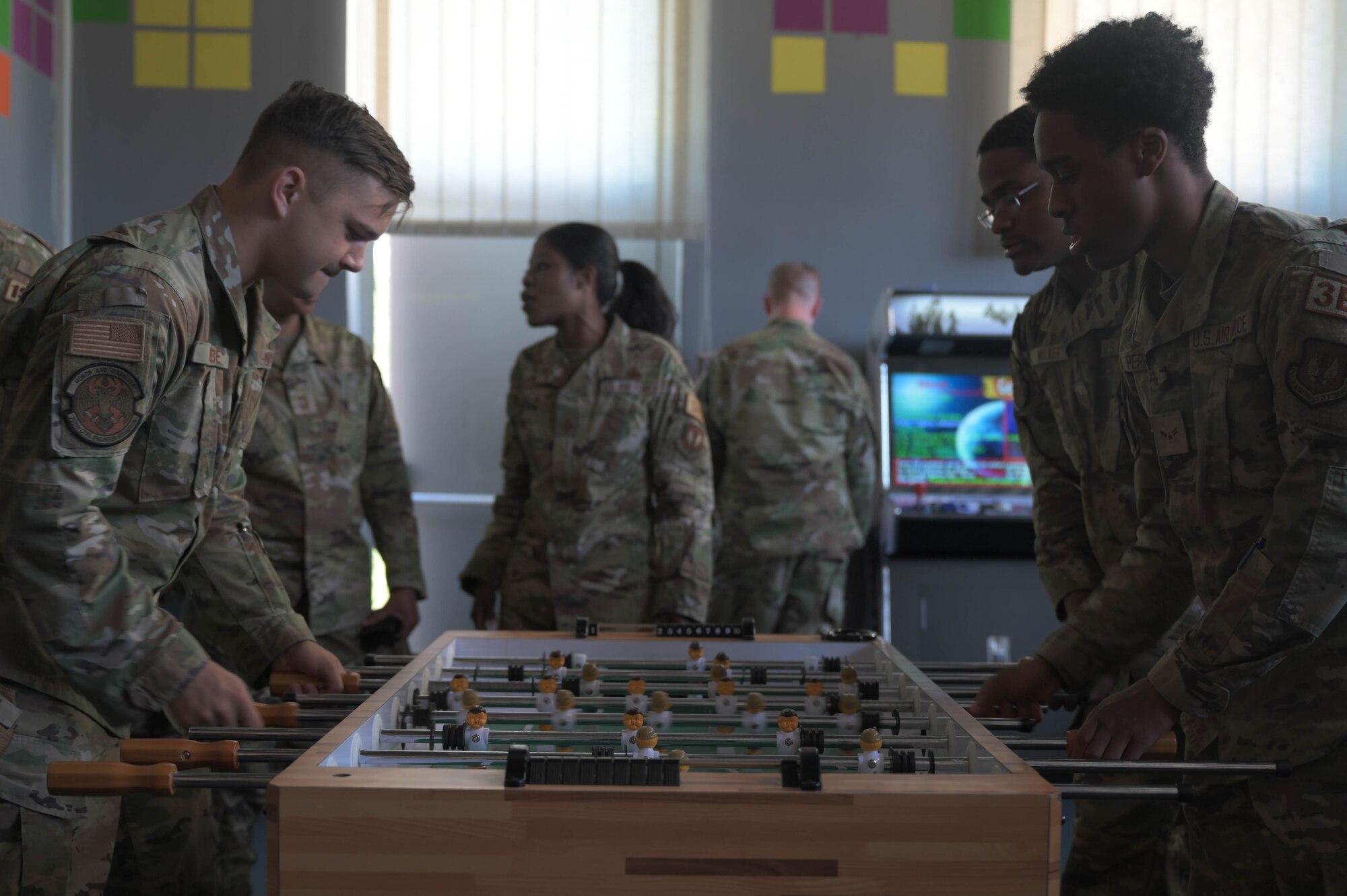 U.S. Air Force Airmen compete in a game of table football at Ramstein Air Base, Germany, June 2, 2023. The game room at The Den features different types of games, from modern consoles to board games. (U.S. Air Force photo by Senior Airman Johnny Foister.)
