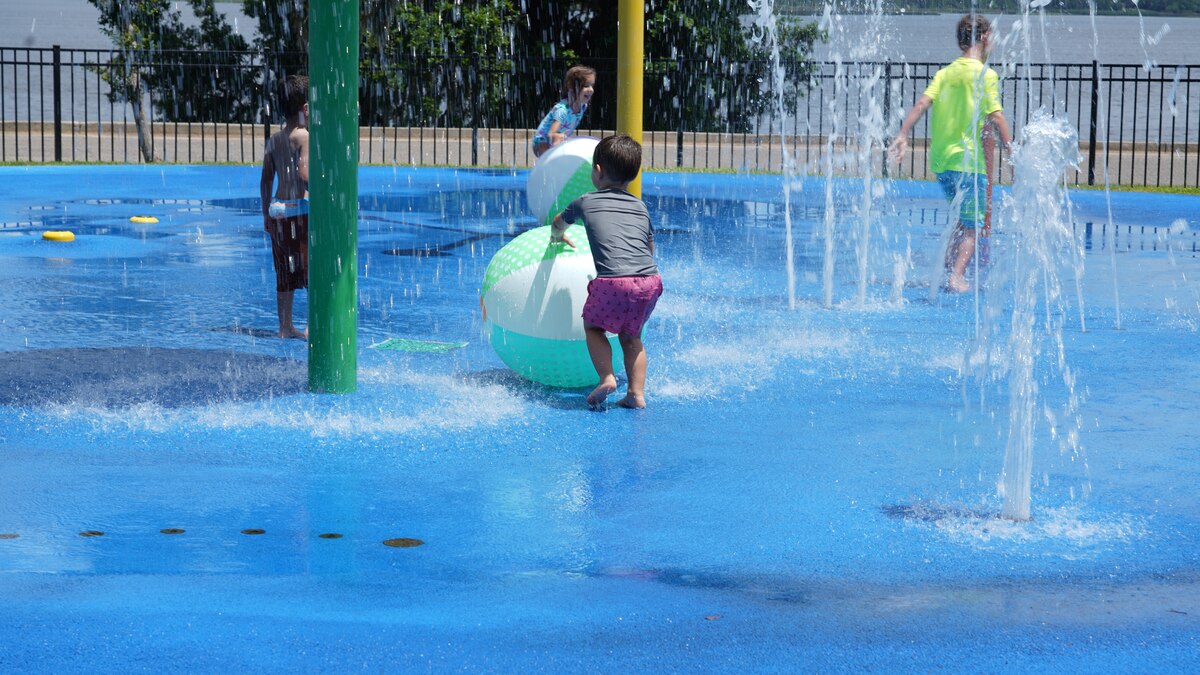 Wing members' families play in the splash pad during the family day celebration.