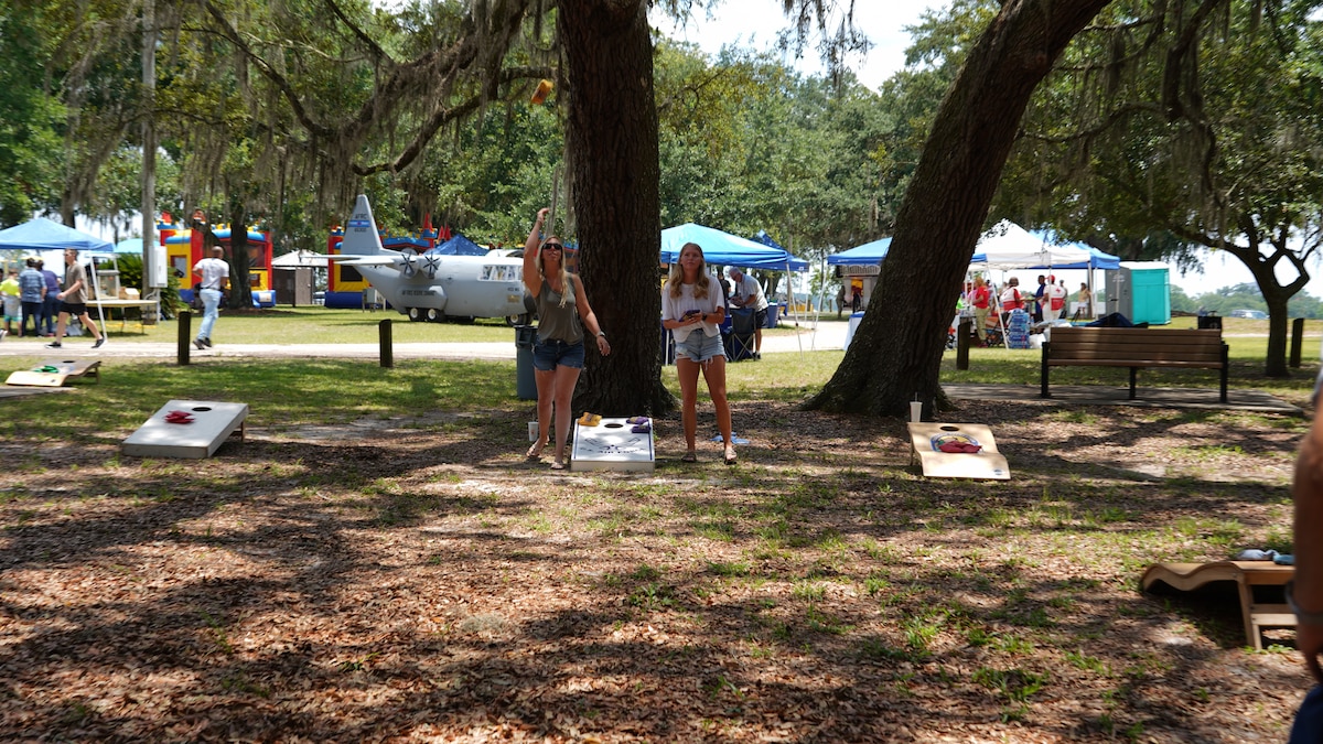Wing members play cornhole during the family day celebration.