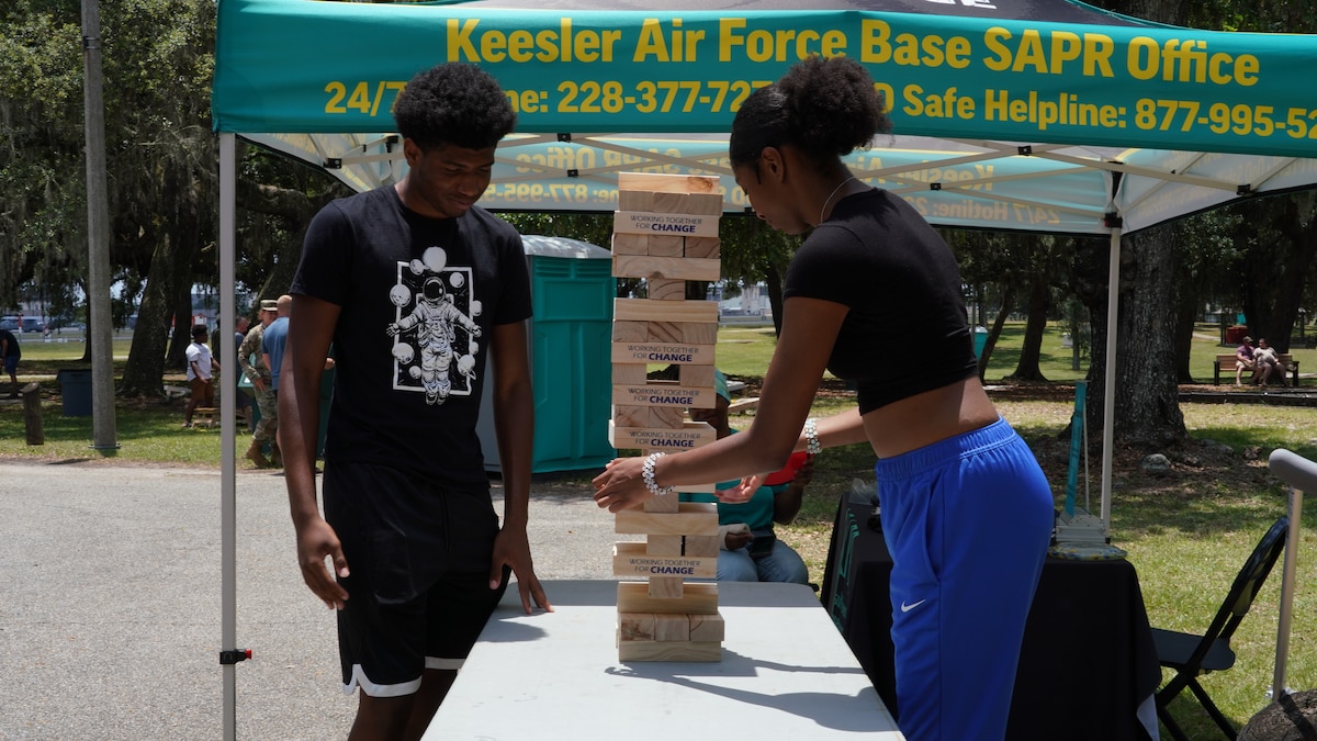 Wing members play an outdoor block game.