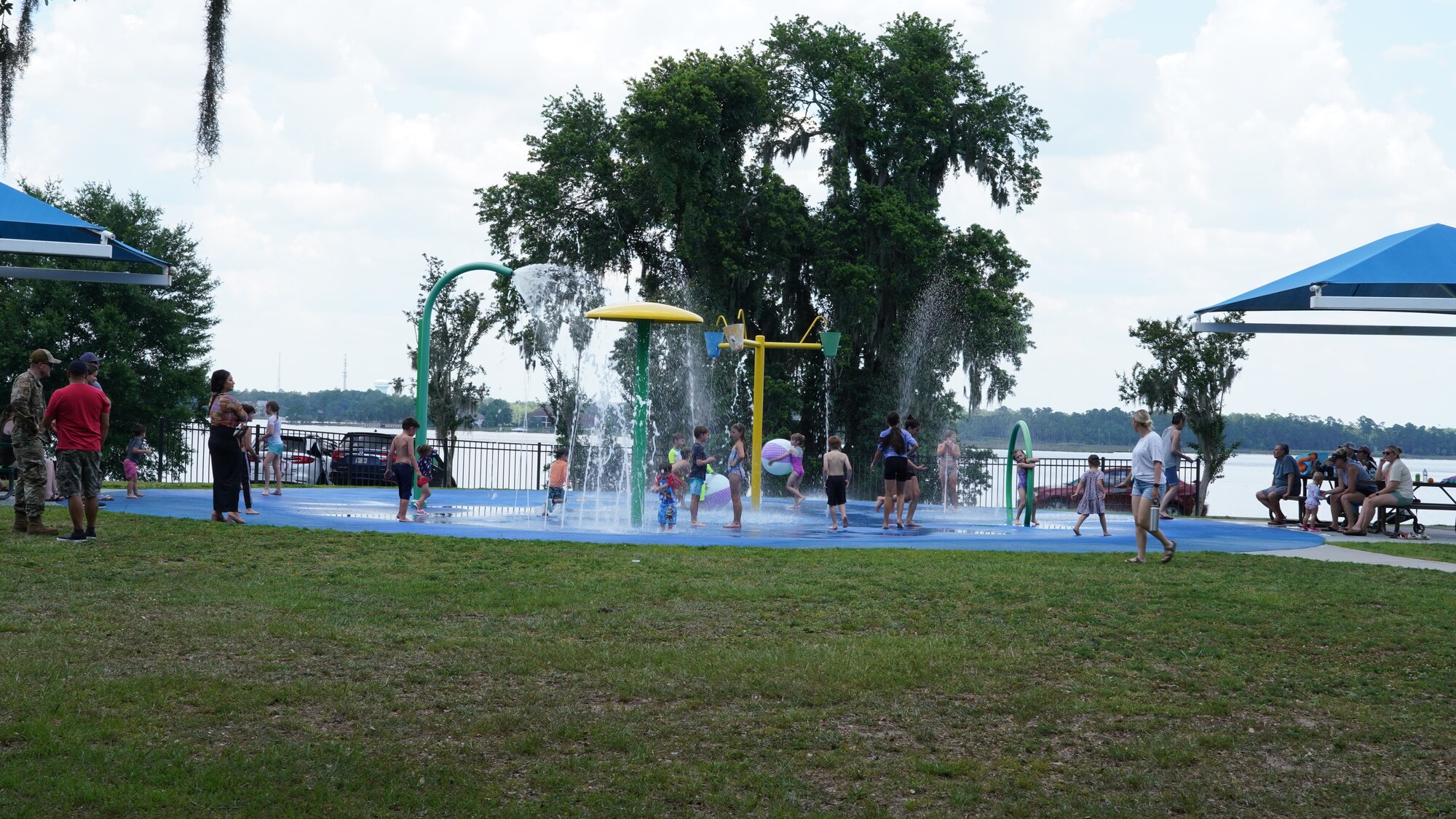 Wing members' families play in the splash pad during the family day celebration.