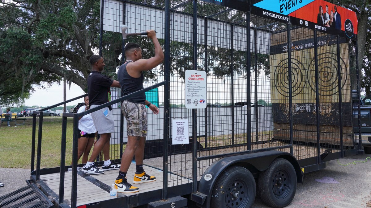 Wing members throw axes during the family day celebration.