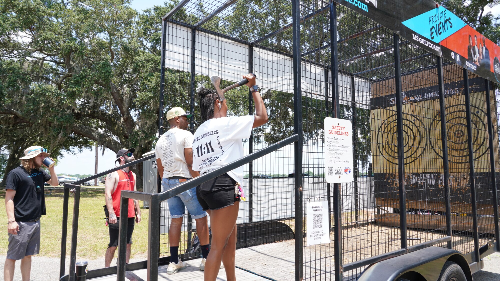 Wing members throw axes during the family day celebration.