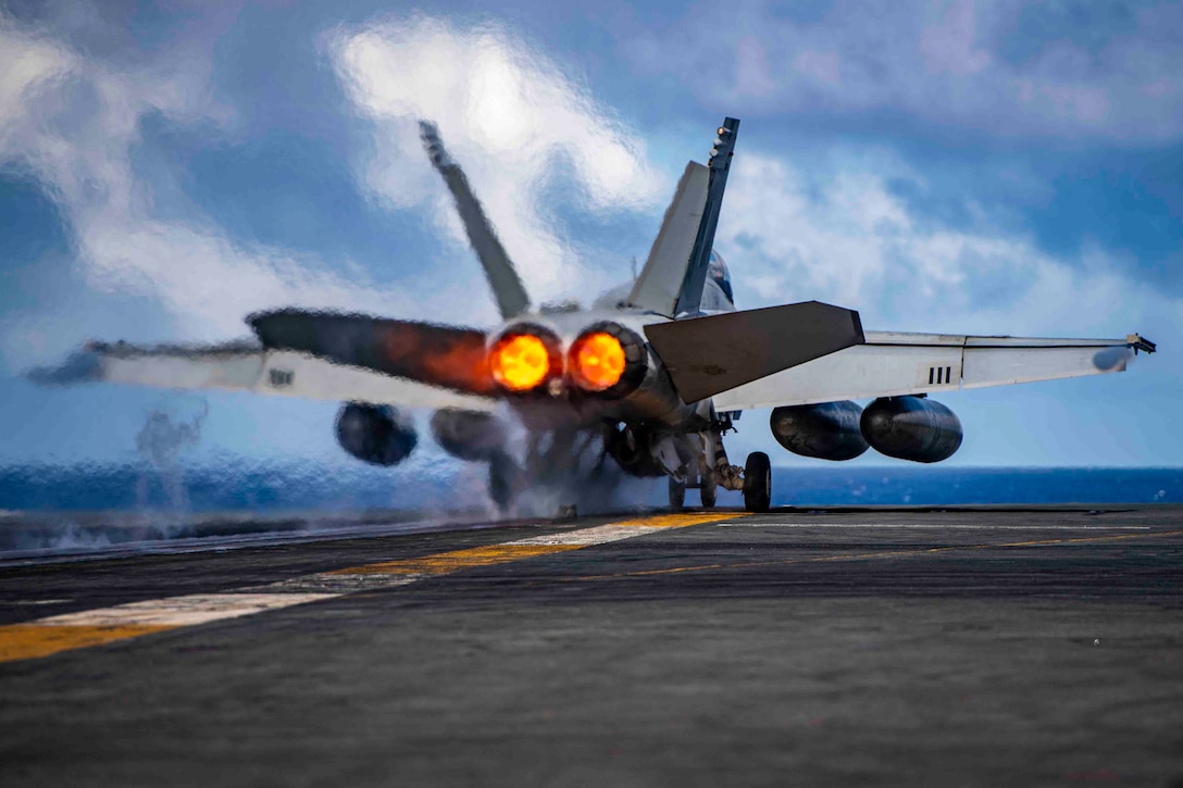 An aircraft takes off from the deck of a ship.