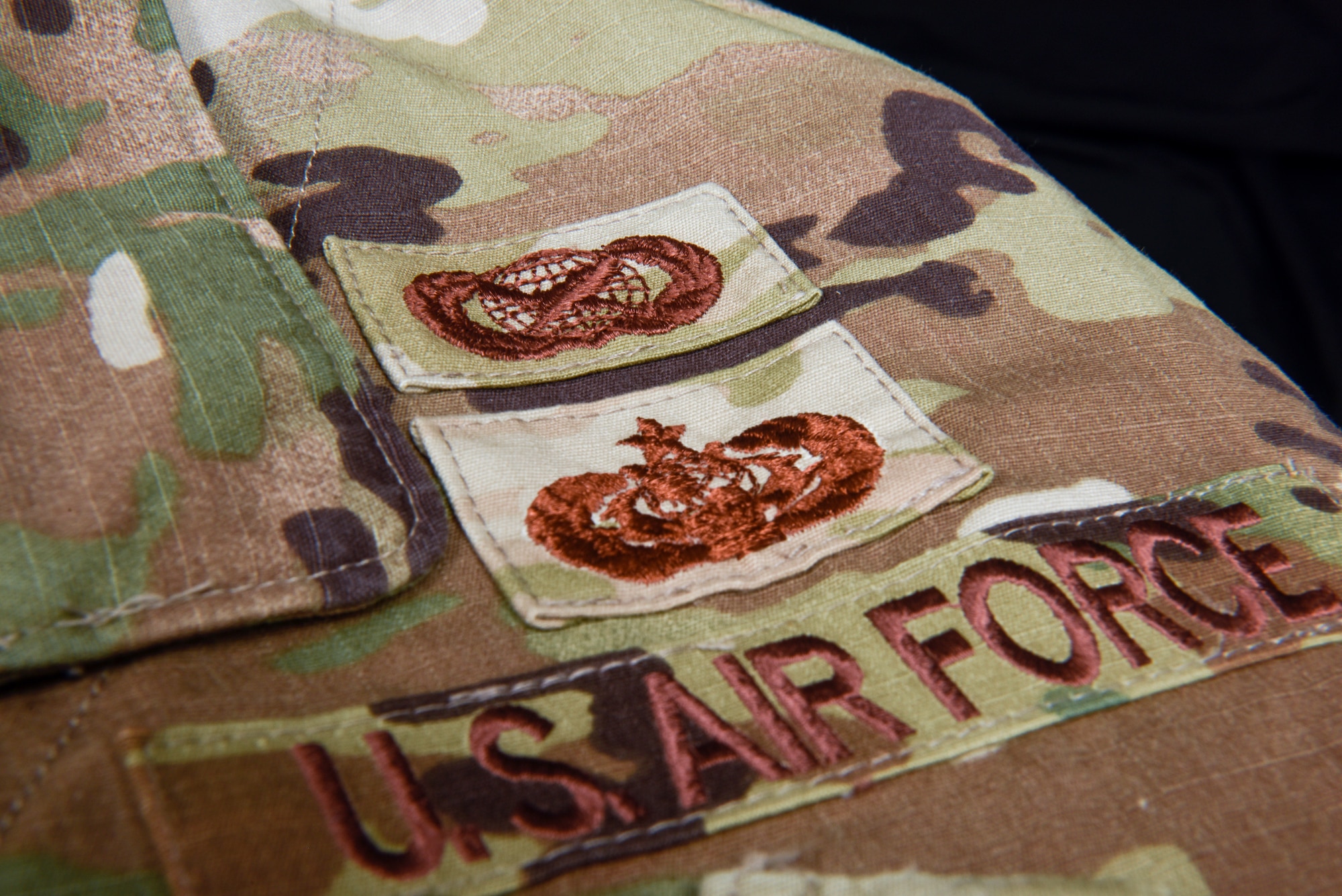 An operational camouflage pattern blouse demonstrates two occupational badges June 01, 2023 at Beale Air Force Base, Calif.