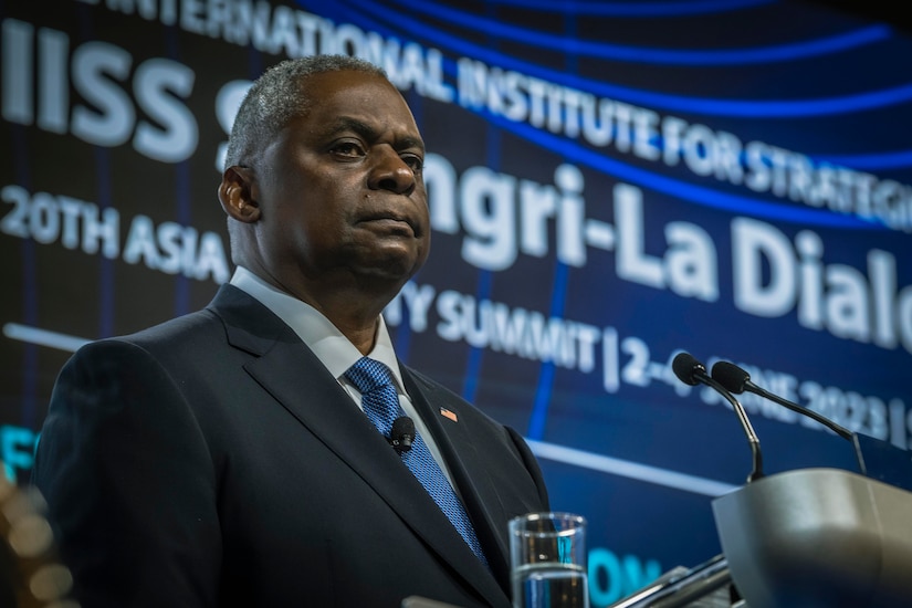 A man stands at a lectern.