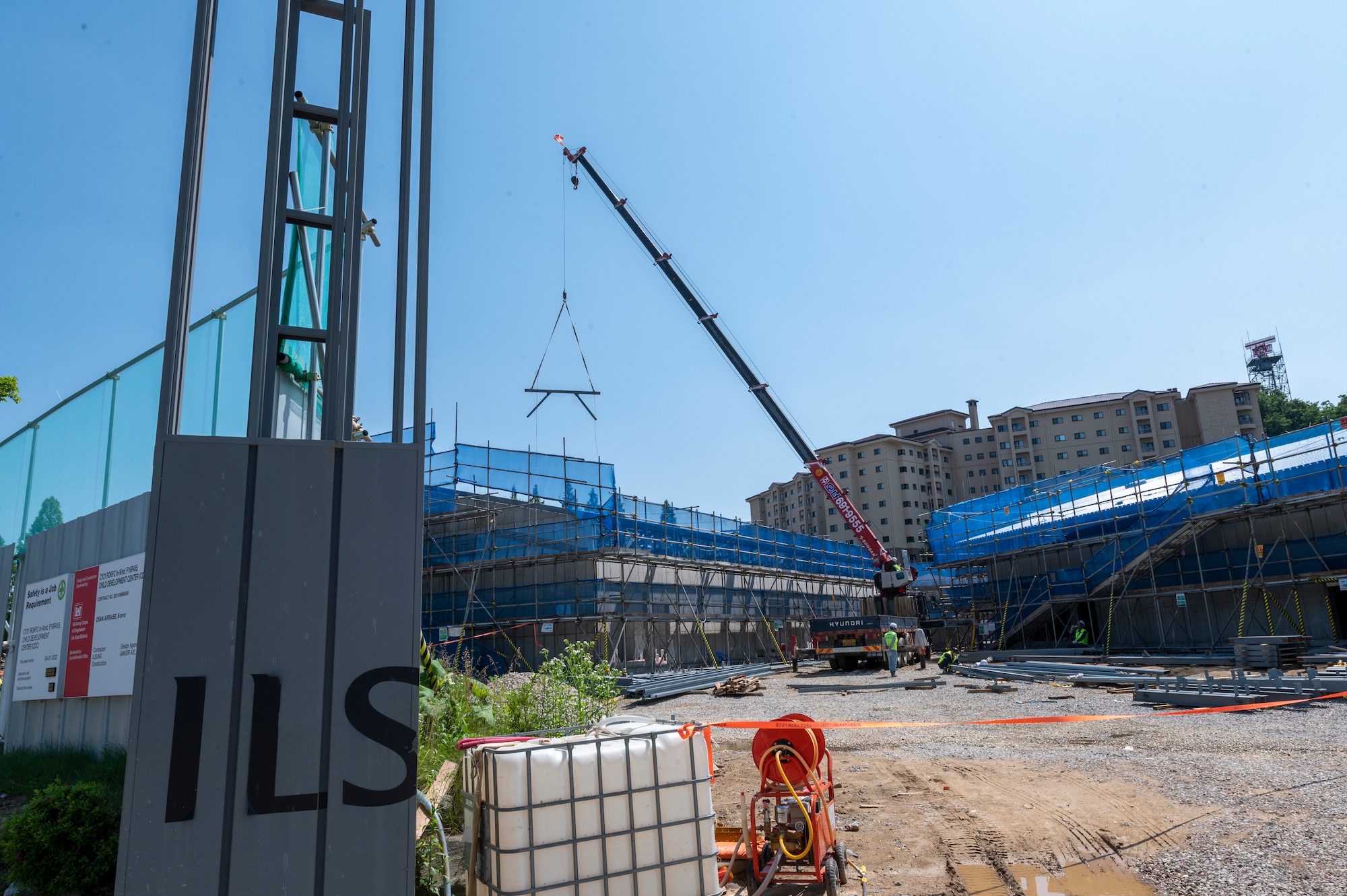 Construction workers build a new child development center (CDC) at Osan Air Base, Republic of Korea, May 31, 2023. The new CDC will combine both the School Aged Care program and the current CDC. Together, both facilities house around 100 students and staff. When combined, the new CDC will be able to hold nearly 300. (U.S. Air Force photo by Airman 1st Class Aaron Edwards.)