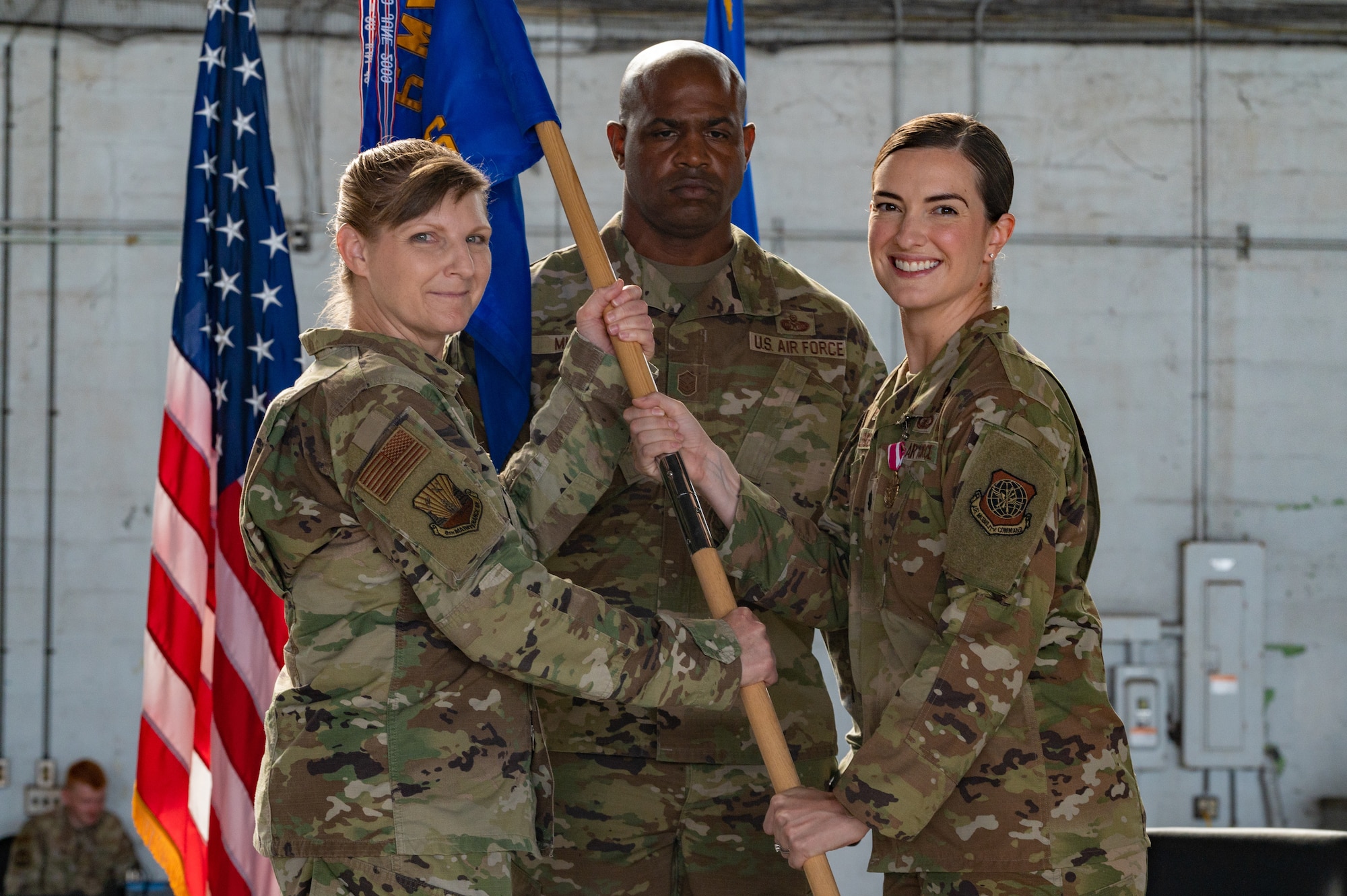 U.S. Air Force Col. Charity Banks, 6th Maintenance Group commander, transfers the flag from U.S. Air Force Lt. Col. Jennifer Lindberg, 6th Aircraft Maintenance Squadron outgoing commander, during the change of command ceremony at MacDill Air Force Base, Florida, June 5, 2023.