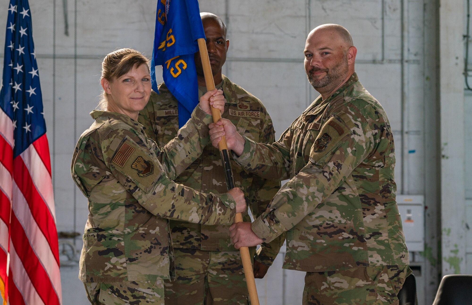 U.S. Air Force Col. Charity Banks, 6th Maintenance Group commander, hands the flag to U.S. Air Force Maj. Aaron Darty, 6th Aircraft Maintenance Squadron incoming commander, during the change of command ceremony at MacDill Air Force Base, Florida, June 5, 2023.