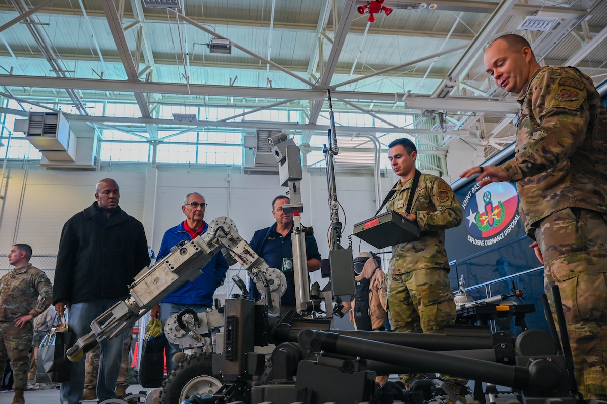 Master Sgt. Robert Pinkston, 433rd Civil Engineer Squadron Explosive Ordnance Disposal programmanager, demonstrates the capabilities of a bomb disposal robot during the Honorary Commanderstour at Joint Base San Antonio-Lackland, Texas, Feb. 4, 2023. The Explosive Ordnance Disposal demo wasa portion of the 433rd Airlift Wing Honorary Commanders program tour of the 433rd Mission SupportGroup. (U.S. Air Force photo by Senior Airman Mark Colmenares)