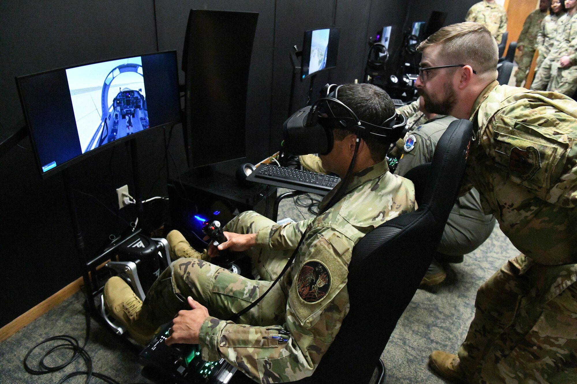 Man in military uniform flies aircraft simulator