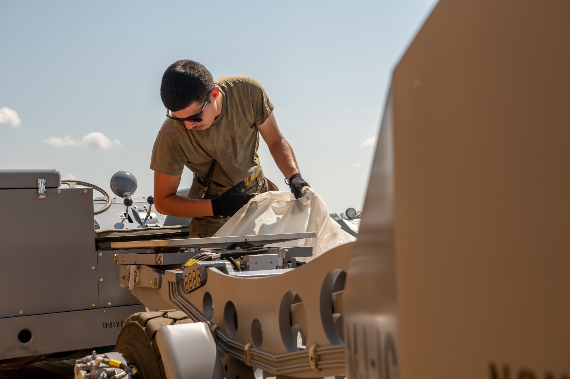 Airmen removes plastic wrap