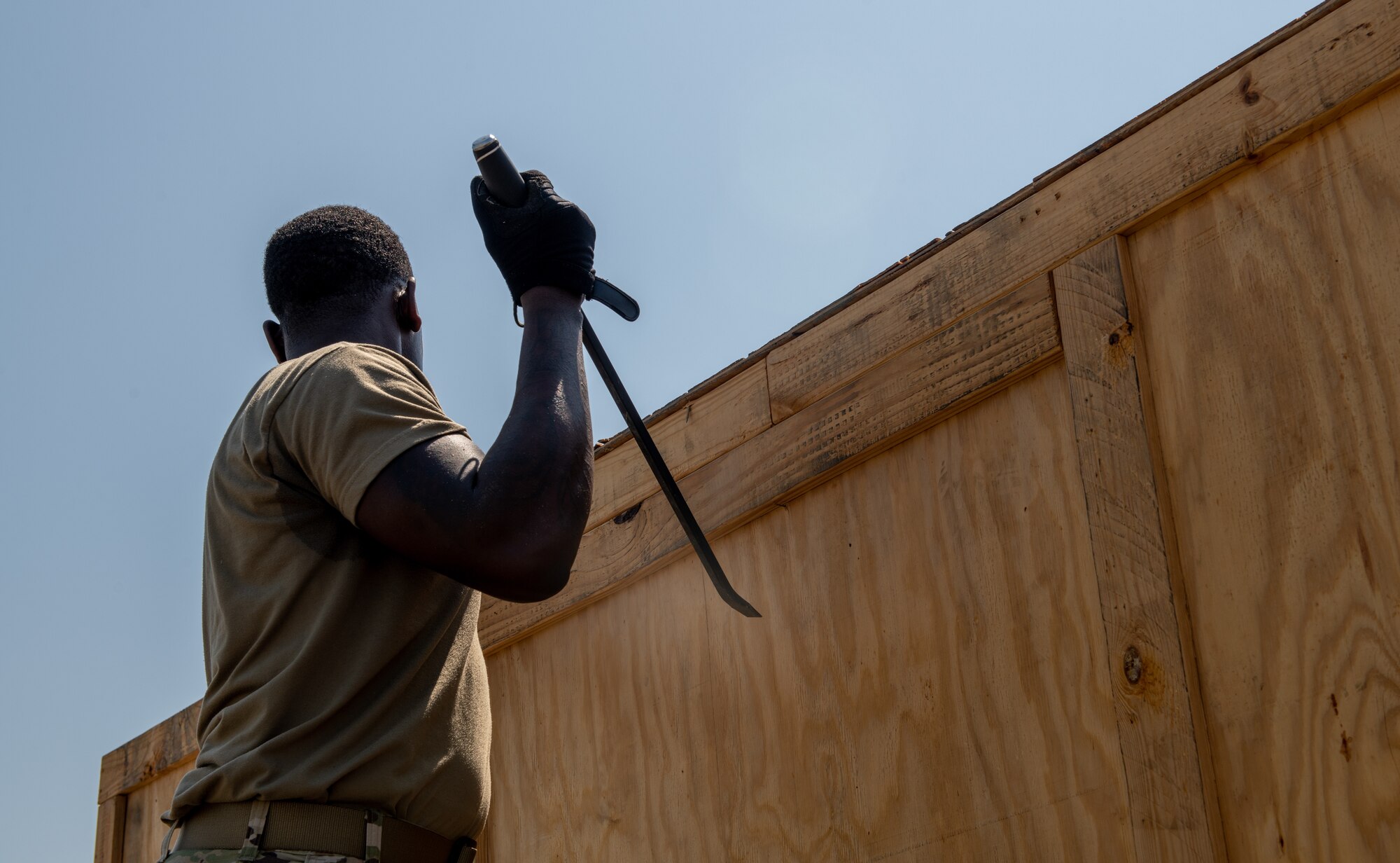 Airmen removes the top of a crate