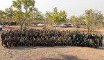 U.S. Marines with Marine Rotational Force – Darwin 23, Australian Army Soldiers, and Indonesian National Armed Forces, pose for a group photo during the closing ceremony for Exercise Crocodile Response 23 at Mount Bundey Training Area, Northern Territory, Australia, May 24, 2023. Crocodile Response is a trilateral engagement between the Australian Defence Force, Indonesian National Armed Forces, and MRF-D that extends shared interoperability throughout the Indo-Pacific, increasing efficiencies in responding to crisis and contingency. (U.S. Marine Corps photo by Cpl. Adeola Adetimehin)