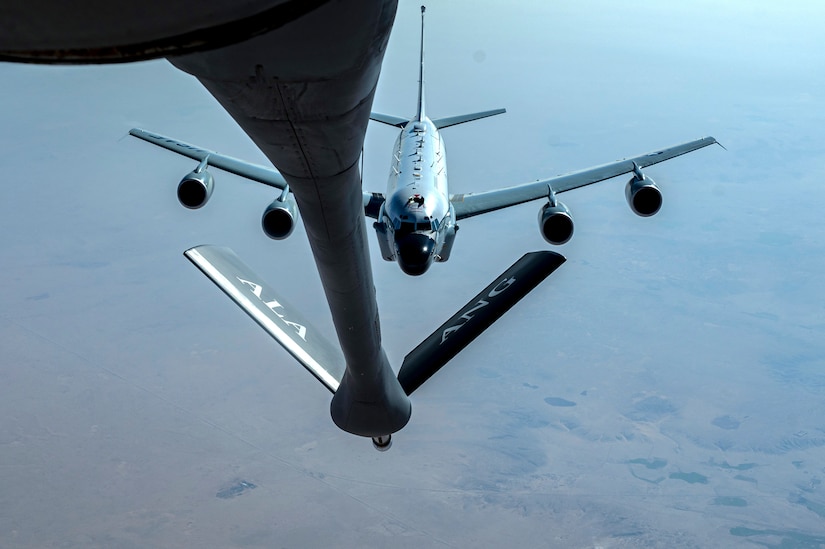 One aircraft approaches the refueling boom extended from another aircraft.