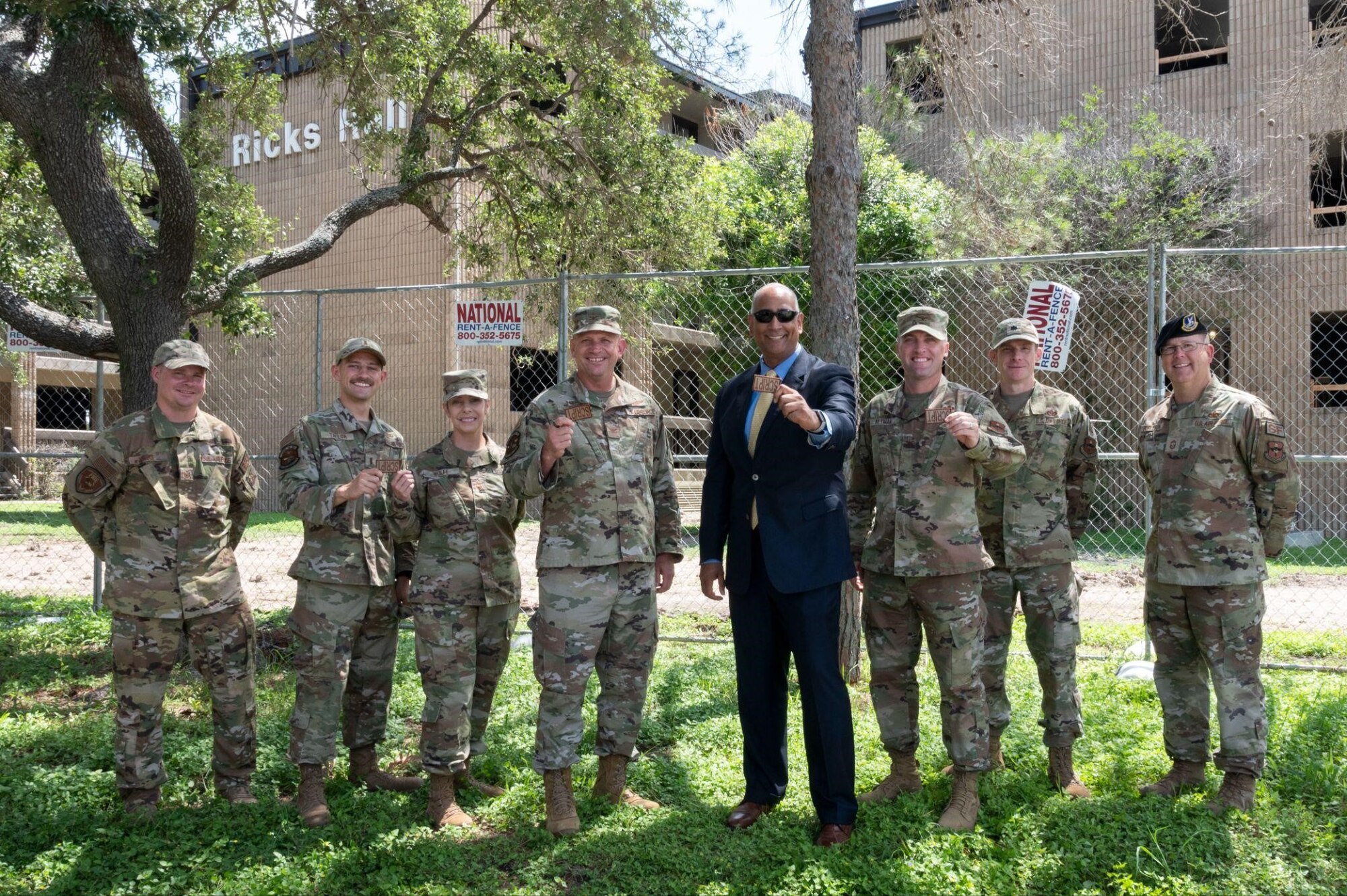 The Hon. Ravi Chaudhary (middle), Assistant Secretary of the Air Force for Energy, Installations, and Environment, stands with leadership members in front of an enlisted dormitory being renovated at Laughlin Air Force Base, Texas, on May 31, 2023. (U.S. Air Force photo by Airman 1st Class Kailee Reynolds)