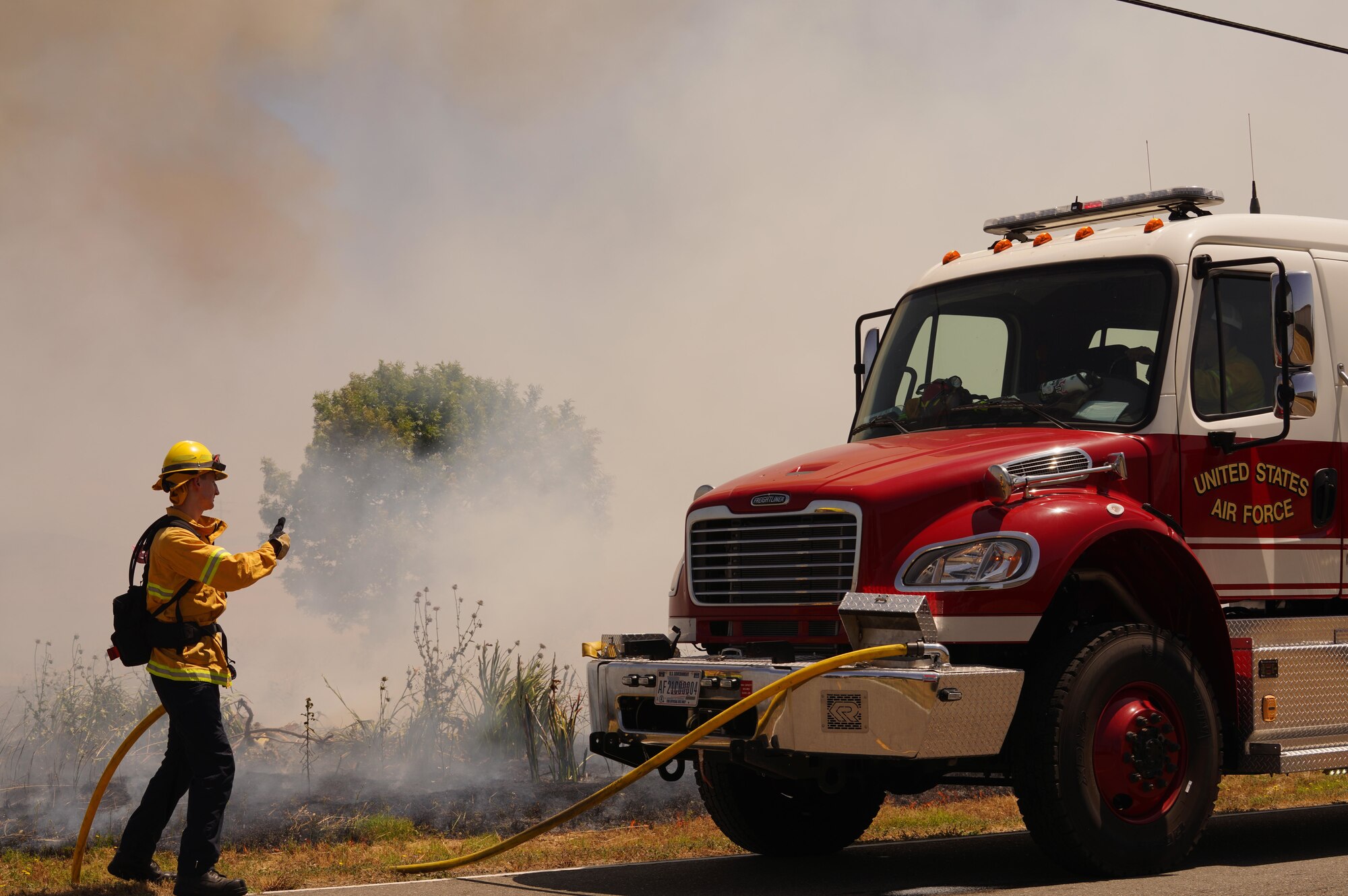 A Wildland Support Module member signals to a driver during a prescribed burn June 2, 2023, at Beale Air Force Base, California.