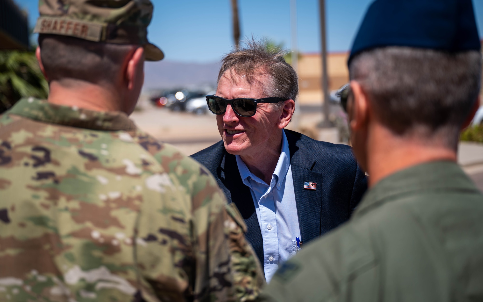 U.S. Representative Paul Gosar shakes hands with Chief Master Sgt. Jason Shaffer while smiling