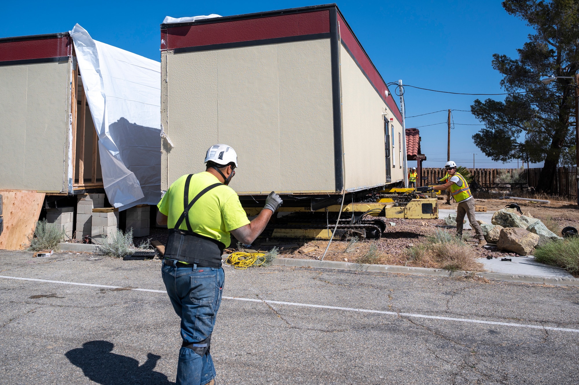 Ground crews move a temporary office building used during the 412th Medical Group's Medical Facilities Modernization Project on Edwards Air Force Base, California, June 2. (Air Force photo by Harley Huntington)