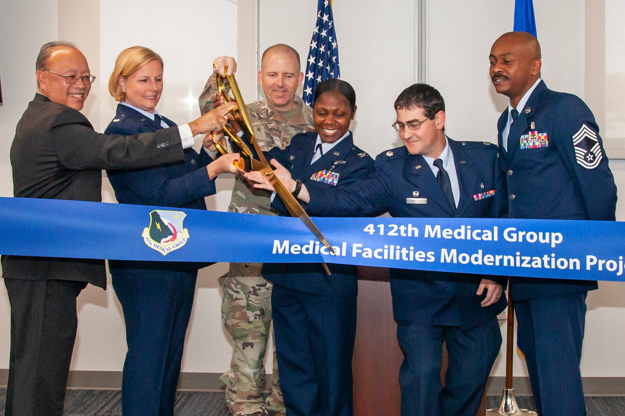 Brig. Gen. Matthew Higer, 412th Test Wing Commander, joins the 412th Medical Group leadership in a ribbon cutting officially opening five facilities within the medical clinic campus, June 1. (Air Force photo by Carla Escamilla)