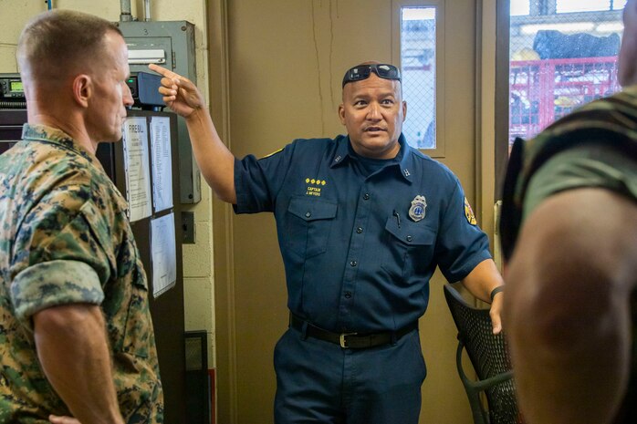 U.S. Marine Corps Maj. Gen. Stephen E. Liszewski, left, commanding general of Marine Corps Installations Pacific, tours Federal Fire Station 8, Marine Corps Base Hawaii, with Jason Meyers, the battalion chief of Battalion 1, District 1, Federal Fire Department Hawaii, May 26, 2023. Liszewski discussed fire station operations and recognized Federal Fire Station 8 for their hard work and dedication to duty. (U.S. Marine Corps photo by Sgt. Julian Elliott-Drouin)