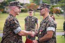 U.S. Marine Corps Maj. Gen. Stephen E. Liszewski, commanding general of Marine Corps Installations Pacific, congratulates Col. Speros C. Koumparakis, commanding officer of Marine Corps Base Hawaii, during an awards ceremony at MCBH, May 25, 2023. Koumparakis received a Legion of Merit medal for his exceptionally meritorious conduct in the performance of outstanding service as the commanding officer of MCBH. (U.S. Marine Corps photo by Sgt. Julian Elliott-Drouin)