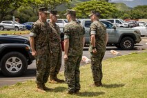U.S. Marine Corps Maj. Gen. Stephen E. Liszewski, commanding general of Marine Corps Installations Pacific, and Sgt. Maj. Joseph Caputo, sergeant major of Marine Corps Base Hawaii, prepare to present Sgt. Zacharia M. Rogers with Provost Marshal’s Office, MCBH, with a Navy and Marine Corps Achievement medal at MCBH, May 25, 2023. Rogers and Sgt. Richard B. Belyeatucker were awarded for superior performance in their duties while responding to an emergency medical assistance call on Feb. 17, 2023. (U.S. Marine Corps photo by Sgt. Julian Elliott-Drouin)