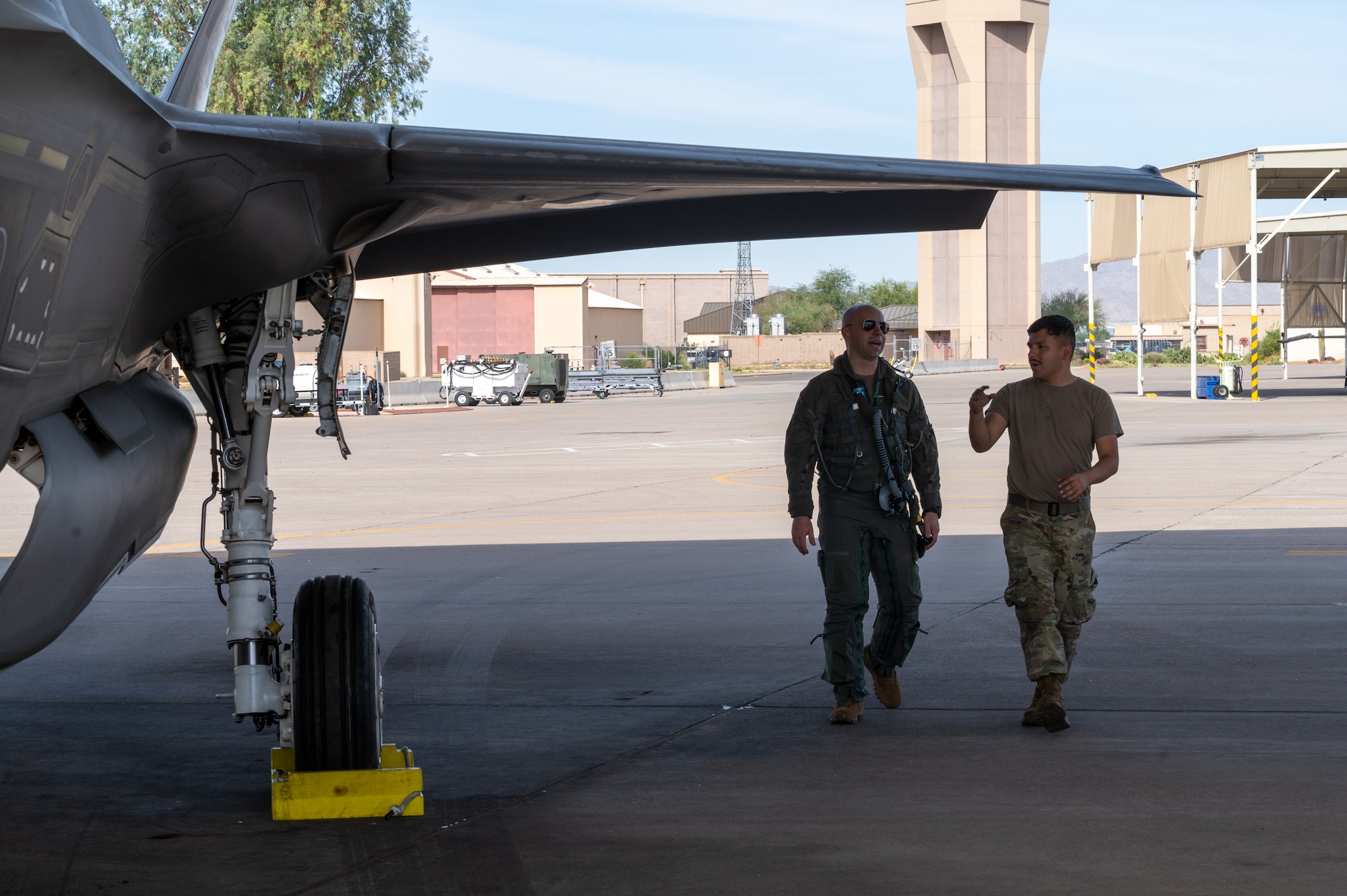 U.S. Air Force Lt. Col. Adam Vogel (left), 310th Fighter Squadron commander, and U.S. Air Force Senior Airman Zachary Calderon (right), 308th Aircraft Maintenance Unit crew chief, conduct a pre-flight maintenance check June 5, 2023, at Luke Air Force Base, Arizona.