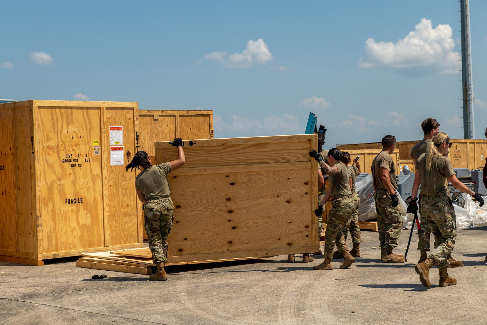 Airmen removes crate materials