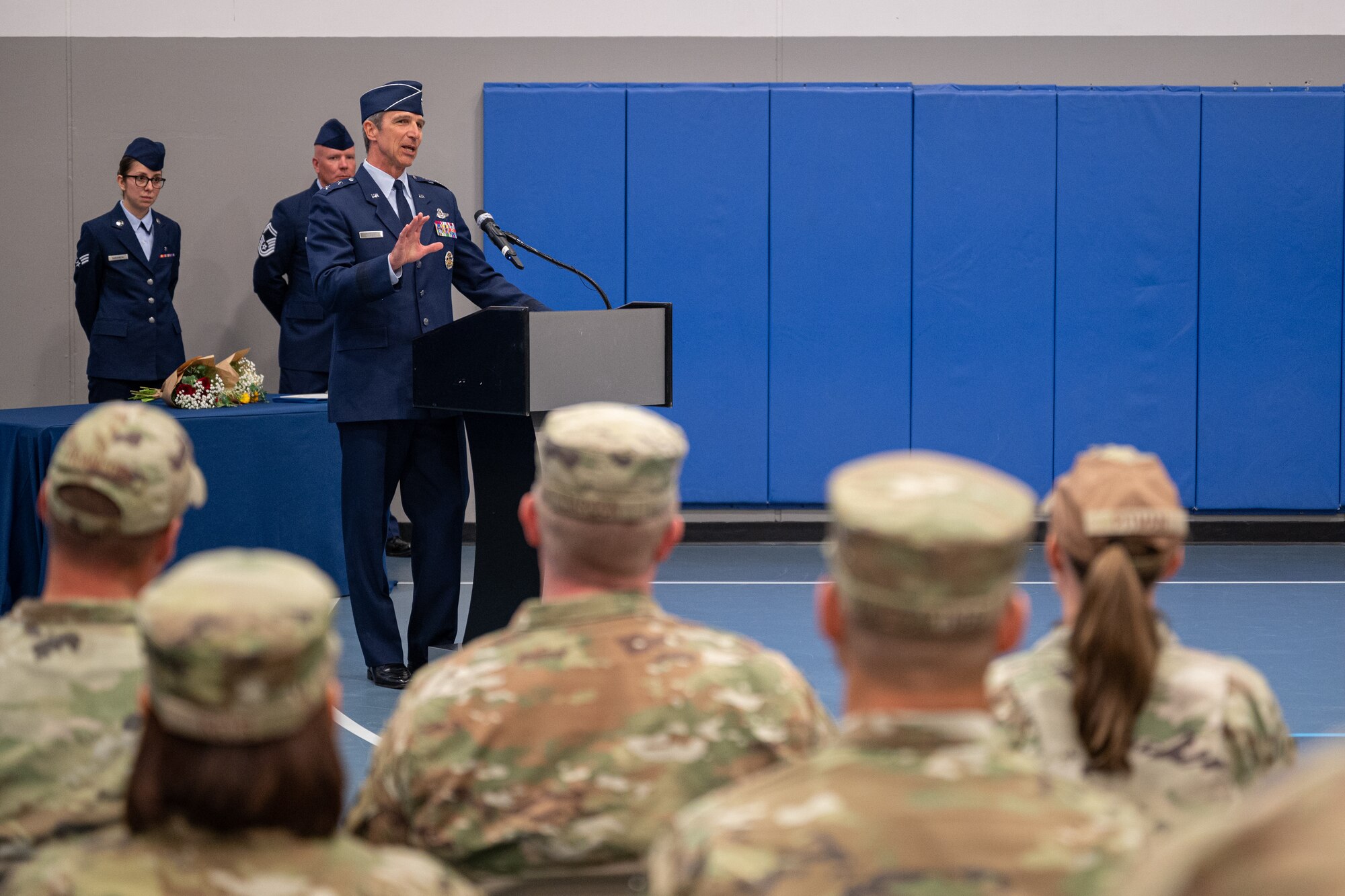 An individual standing at a podium speaks to an audience