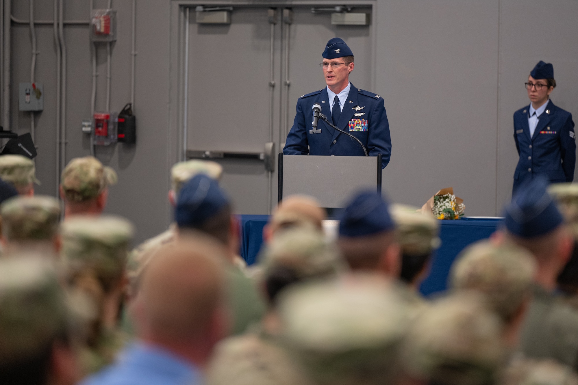 An individual at a podium speaks to an audience.