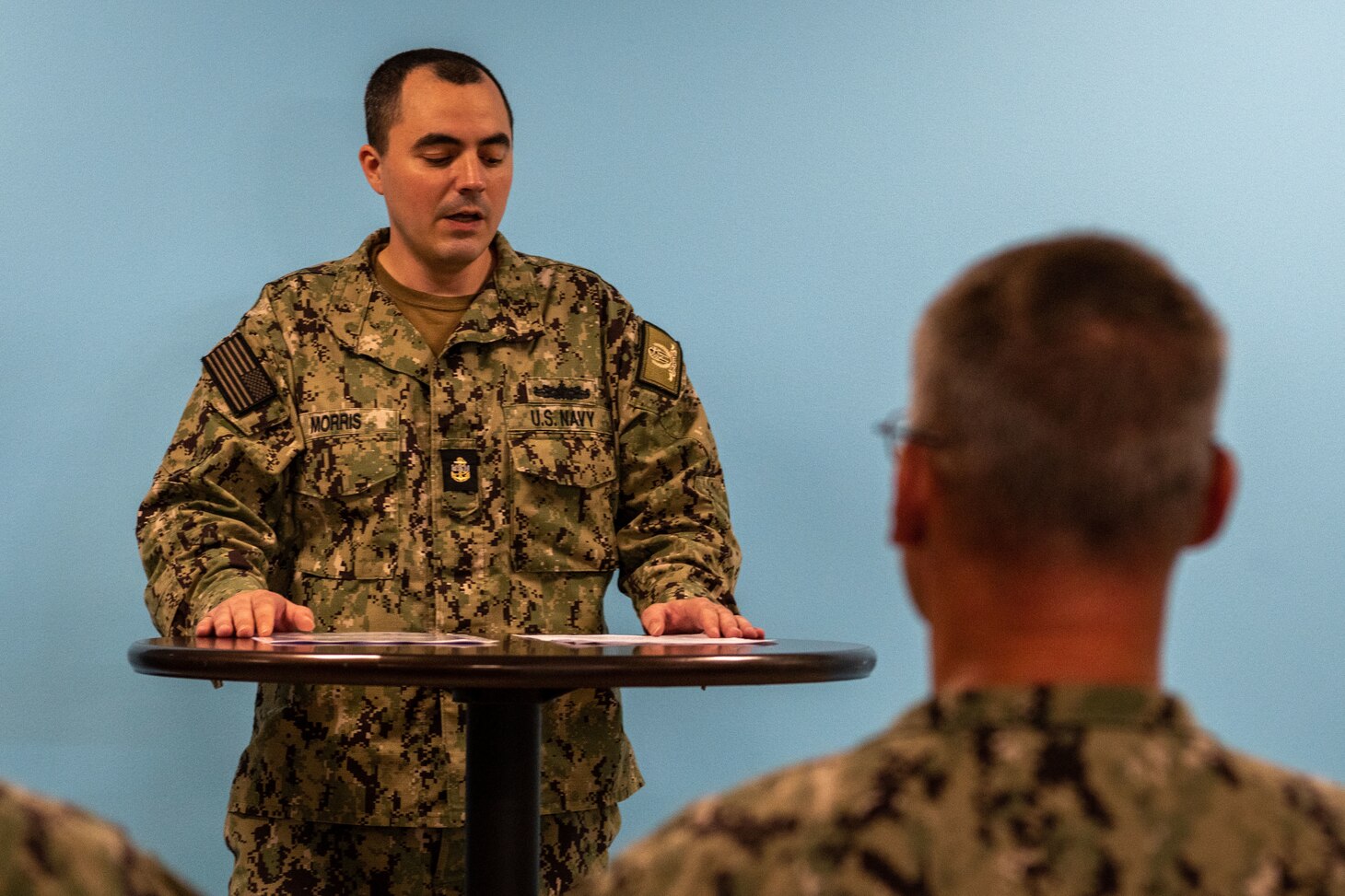 Chief Electronics Technician Corey Morris, assigned to Naval Support Activity (NSA) Souda Bay, talks about the history of the D-Day invasion during a Remembrance Ceremony held in The Anchor on June 6, 2023.