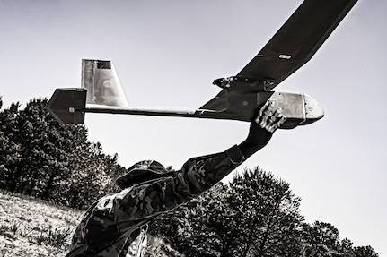 Sgt. Byme Taylor, 1st Battalion, 175th Infantry Regiment infantryman, launches an RQ-11 Raven at Joint Base McGuire-Dix-Lakehurst in New Jersey June 1, 2023. With a flight radius of 6.2 miles and the ability to reach speeds of 31 to 62 mph, the Raven provides better aerial reconnaissance than most drones.