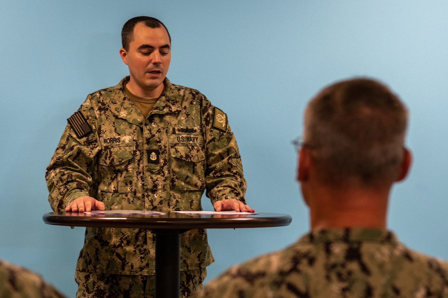 Chief Electronics Technician Corey Morris, assigned to Naval Support Activity (NSA) Souda Bay, talks about the history of the D-Day invasion during a Remembrance Ceremony held in The Anchor on June 6, 2023.