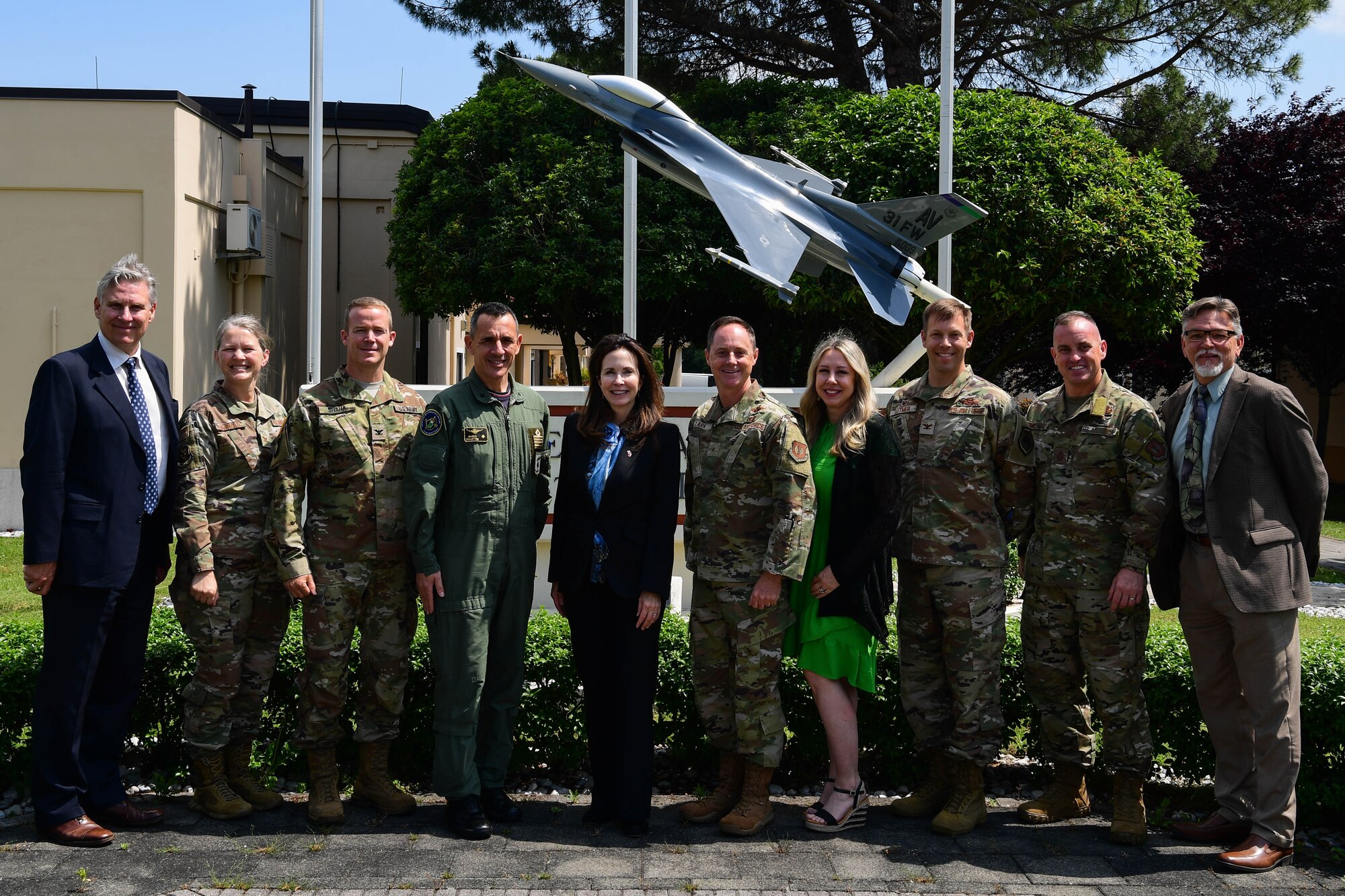 Jamie Harpootlain, U.S. Ambassador to the Republic of Slovenia, poses for a photo with base leadership at Aviano Air Base, Italy, May 1, 2023.