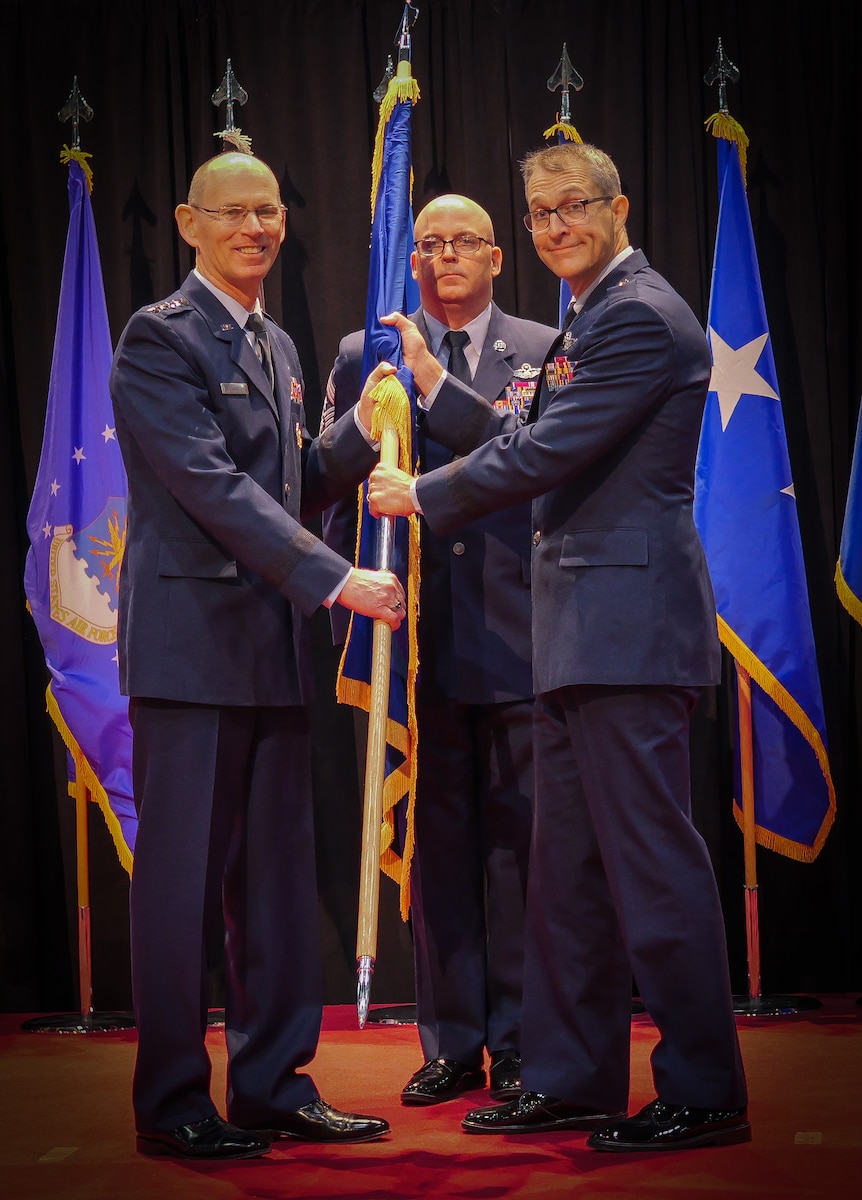Gen. Duke Z. Richardson, left, commander, Air Force Materiel Command, passes command of the Air Force Research Laboratory, or AFRL, to Brig. Gen. Scott A. Cain, right, during a change of command ceremony, while Chief Master Sgt. Bill Fitch, AFRL command chief, stands center at the National Museum of the U.S Air Force, June 5, 2023. Cain was chosen to be the 13th commander of AFRL, having previously served as director of Air, Space and Cyberspace Operations at Headquarters, Air Force Materiel Command. (U.S. Air Force photo / Keith Lewis)