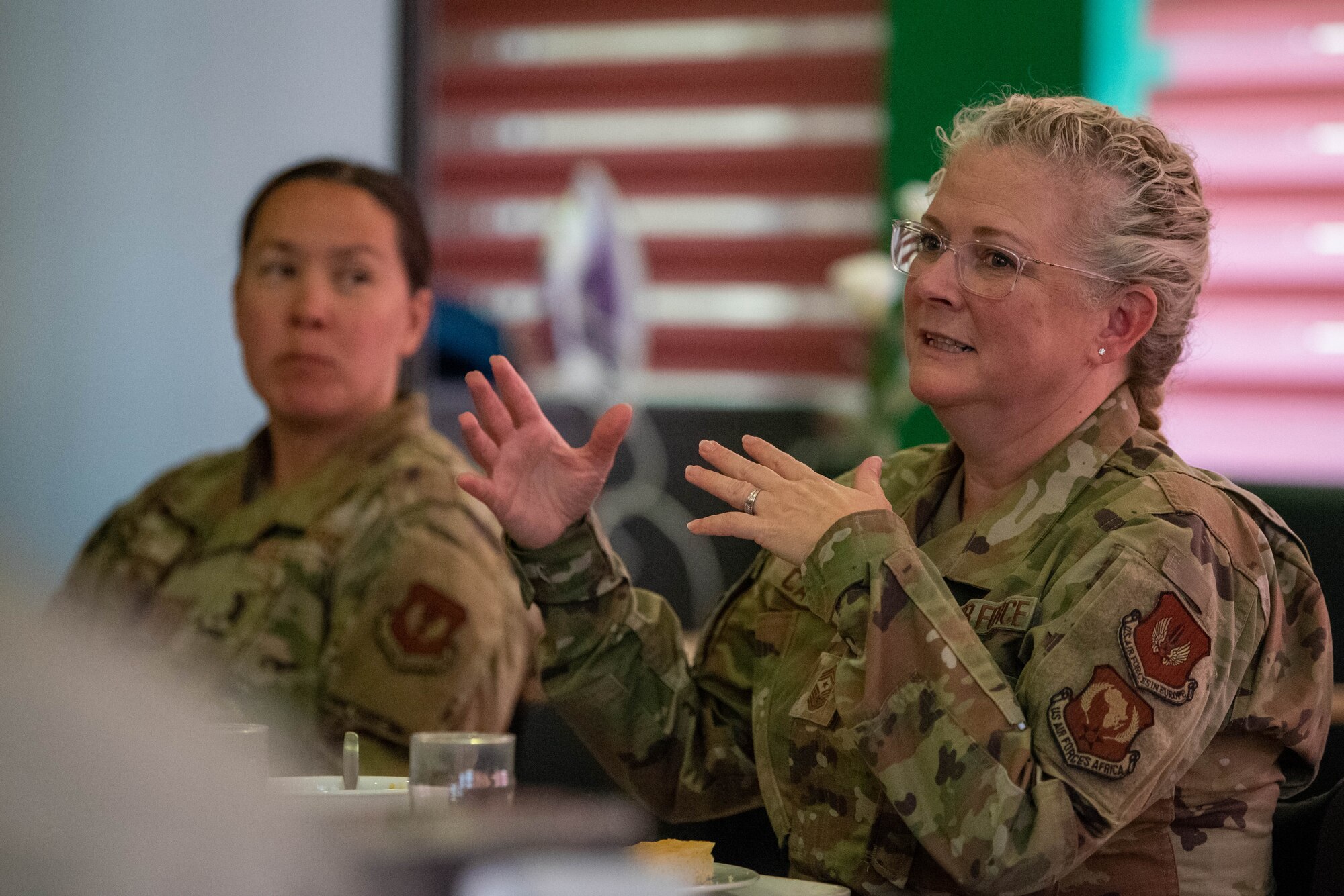 U.S. Air Force Chief Master Sgt. Stephanie Cates, Third Air Force command chief, sits down for lunch with Airmen during a visit