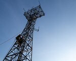 Cable and antenna system technician Airmen with the 219th Engineering Installation Squadron watch as their colleagues scale an antenna tower at Tulsa Air National Guard Base, Okla., June 3, 2023. This training is crucial to the wing mission to ensure Airmen safety and preparedness for future missions. (U.S. Air National Guard Photo by Airman 1st Class Addison Barnes Released)