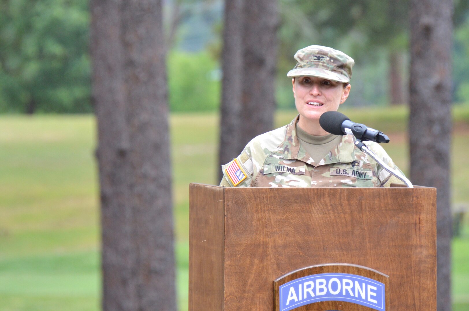 Col. Wilma addresses the crowd from a podium.