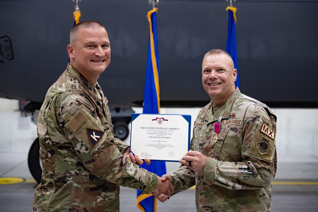 Photo of people shaking hands and holding a certificate