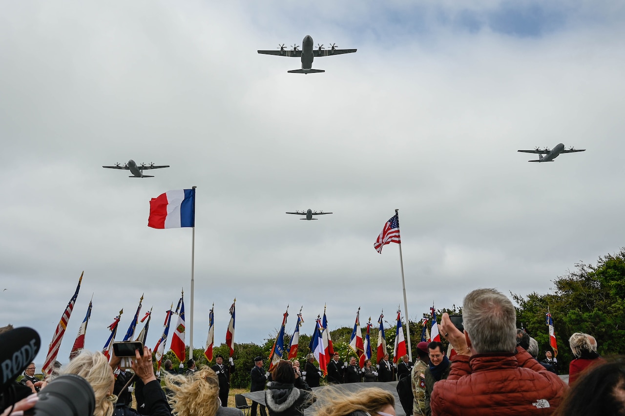 C-130s fly over a D-Day memorial in France.