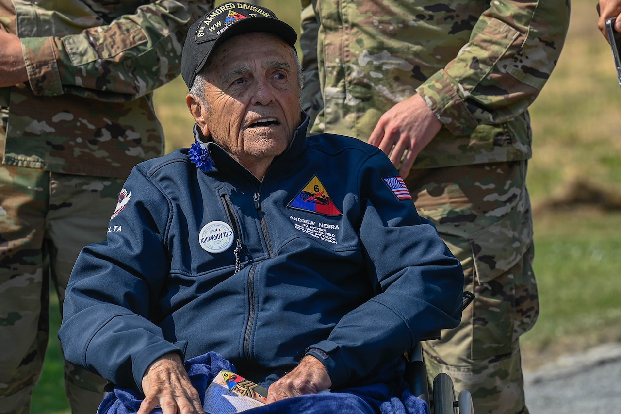 A seated WWII veteran is shown close-up.