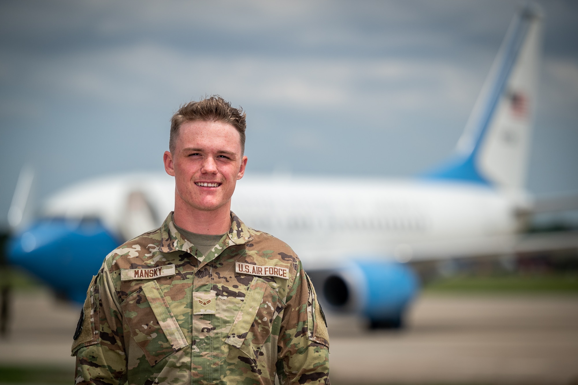 U.S. Air Force Airman 1st Class John Mansky, 932nd Maintenance Group crew chief, shares his Airman's story and takes a moment for a photo with a 932nd Airlift Wing C-40C as the backdrop, May 5, 2023, Scott Air Force Base, Illinois. (U.S. Air Force photo by Christopher Parr)