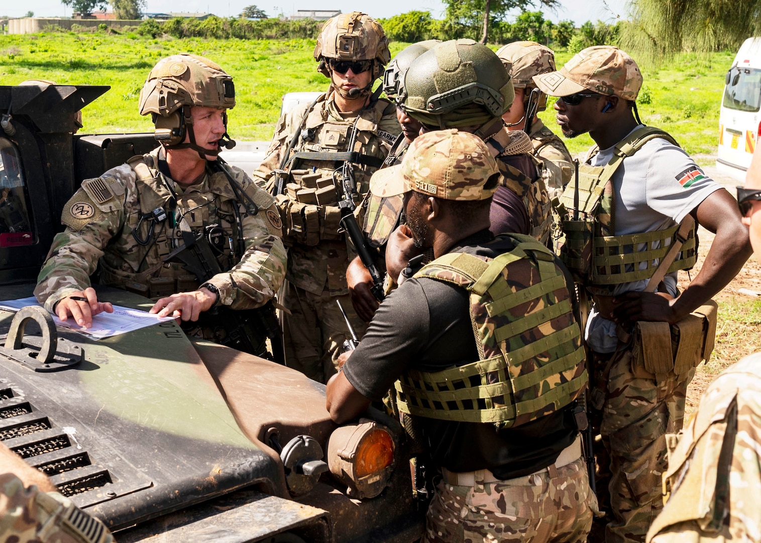 New York Army National Guard 1st Lt. Peter Clark, left, a member of D Company, 1st Battalion, 69th Infantry, goes over defense plans with the Kenyan Defense Force during a base defense drill on Camp Simba, Kenya, May 18, 2023. The Soldiers of Task Force Wolfhound,  a security force based on the 69th Infantry, worked with the Kenyans to review actions in defense of the base.