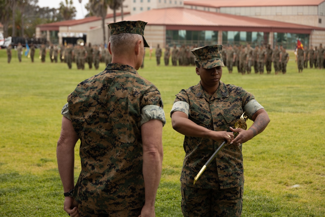 U.S. Marine Corps Sgt. Maj Ronda R. Kirkby, the oncoming sergeant major of 1st Marine Logistics Group, holds the Non-commissioned Officer’s Sword during a relief and appointment ceremony at Camp Pendleton, California, May 11, 2023. The passing of the sword symbolizes the relief of duty from Sgt. Maj. Stennett W. Rey II to Sgt. Maj. Kirkby. The ceremony represents the outgoing sergeant major of 1st MLG, Sgt. Maj. Stennett Rey, relinquishing his duties to the oncoming sergeant major, Sgt. Maj. Ronda Kirkby, and celebrated the retirement of Sgt. Maj. Rey after 29 years of faithful service. (U.S. Marine Corps photo by Lance Cpl. Hannah Hollerud)
