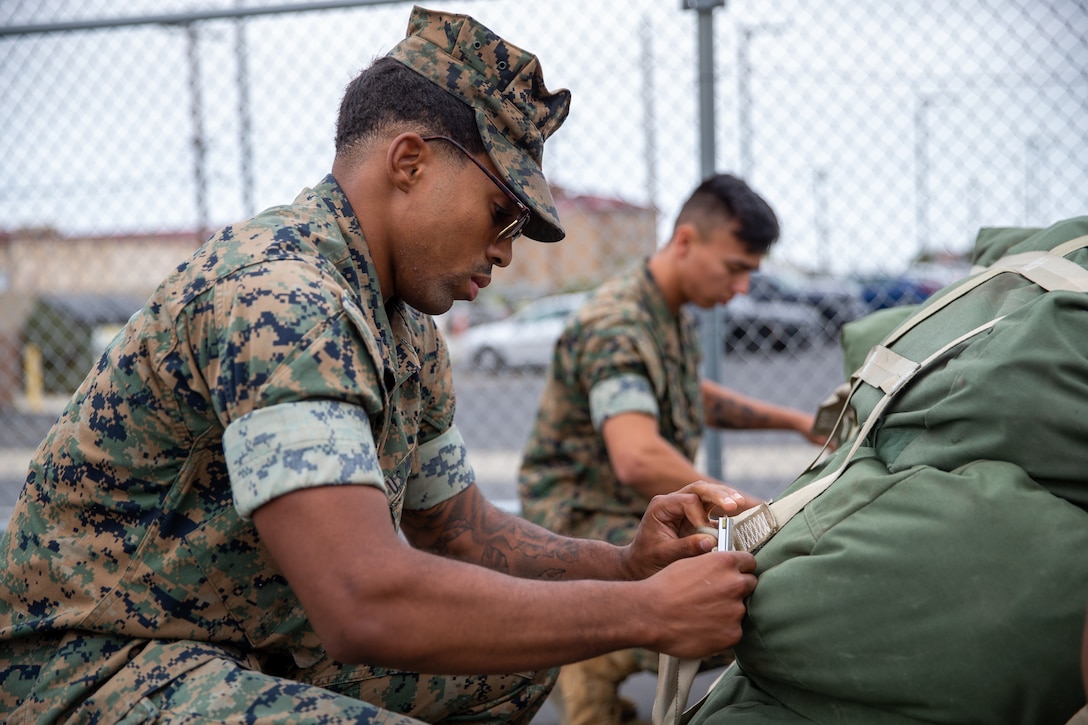 A U.S. Marine with Combat Logistics Battalion 11, 1st Marine Logistics Group, prepares to unstow baggage staged on a 463L cargo pallet during CLB-11’s loading exercise (LOADEX) at Marine Corps Base Camp Pendleton, California, May 17, 2023. The intent of the LOADEX is to prepare, marshal, conduct movements of cargo and personnel, stage, load, and simulate the embarkation of designated unit line numbers of personnel, supplies or equipment to increase major combat operations readiness by enhancing our ability to rapidly mobilized in preparation to support Task Force Koa Moana 23. (U.S. Marine Corps photo by Lance Cpl. Trent A. Henry)