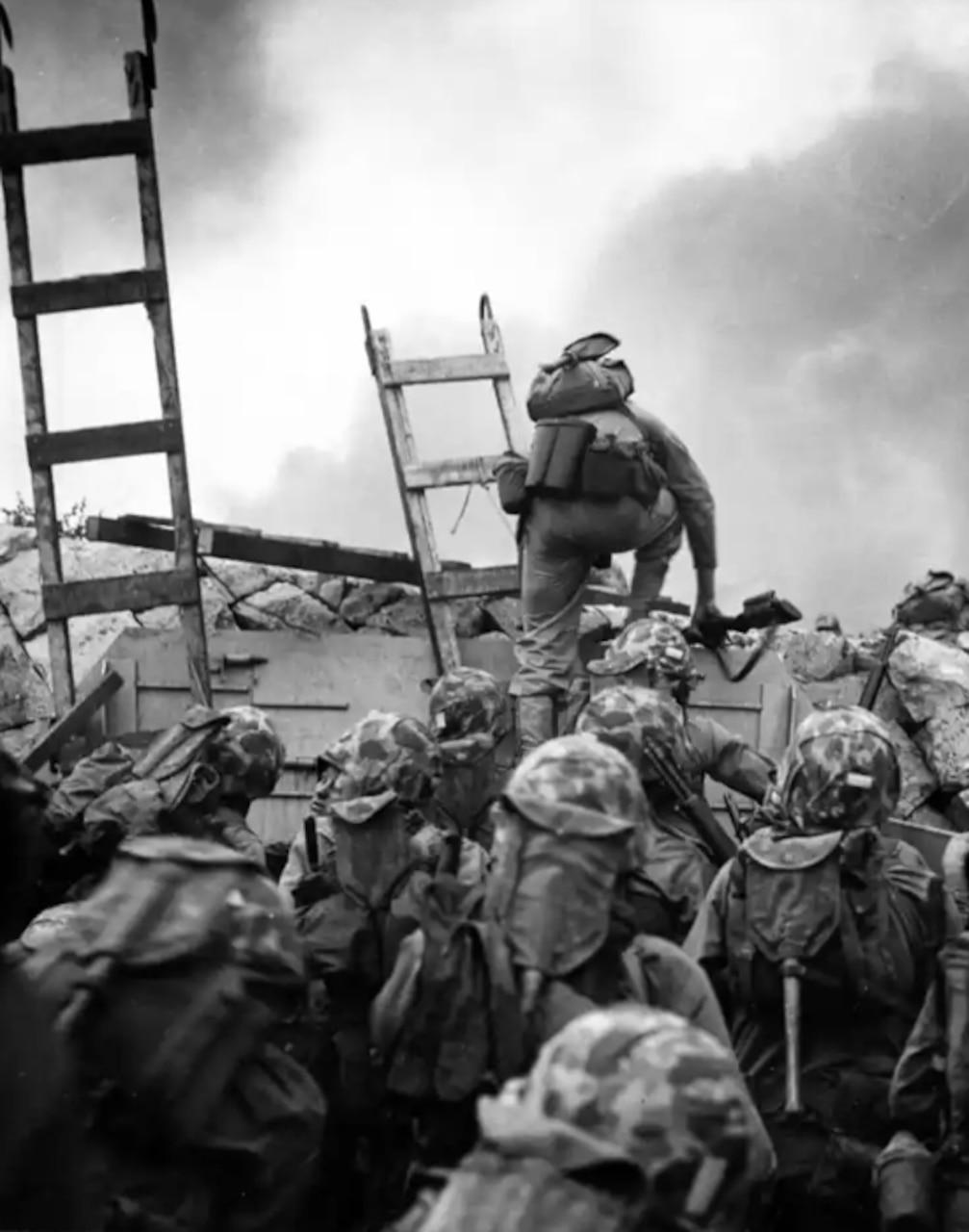 Marines climb their way onto a battlefield.